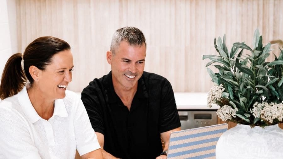Two Hello Capital clients reviewing their finance options at home